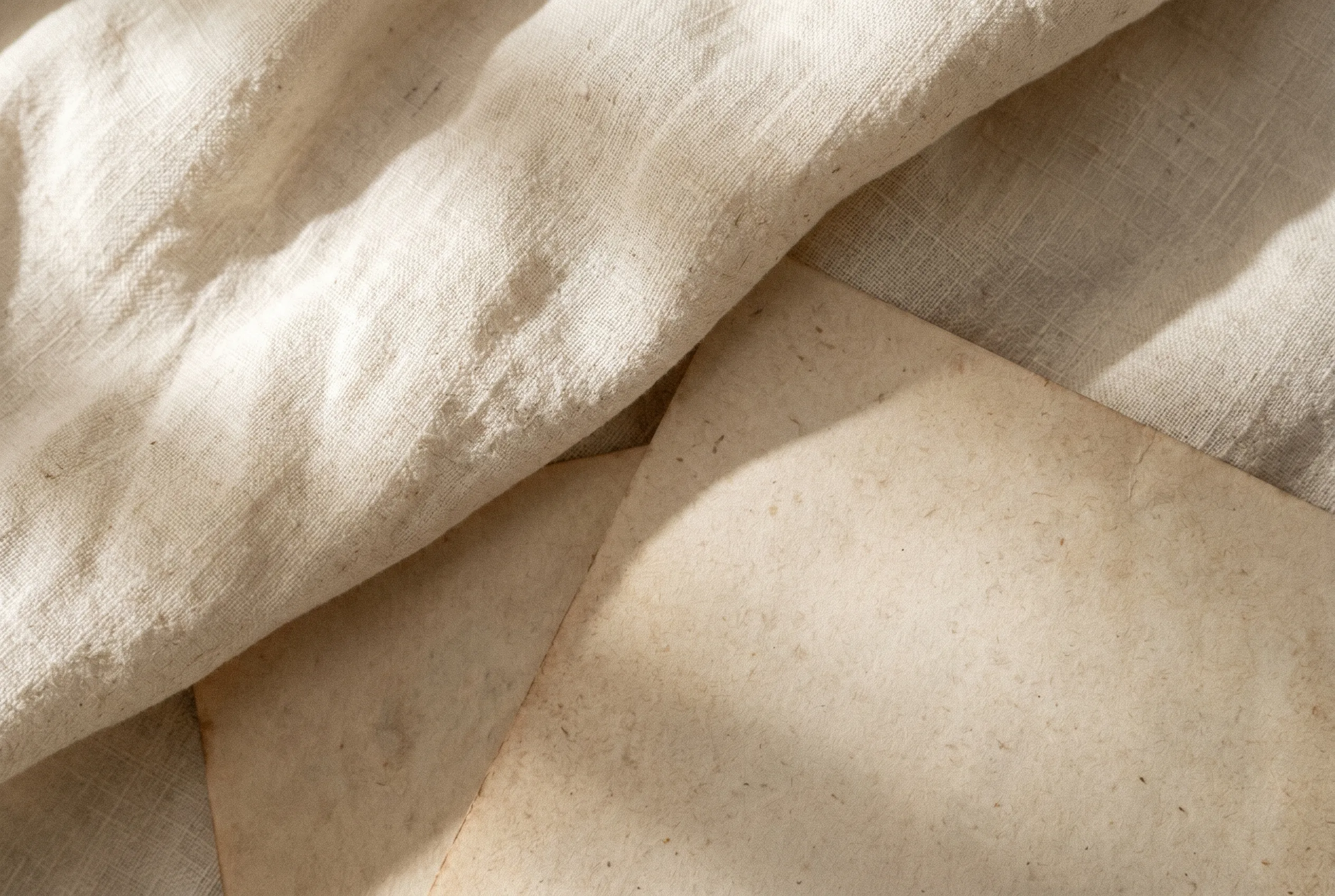 Layered linen and parchment — a study in warm, honest materials.